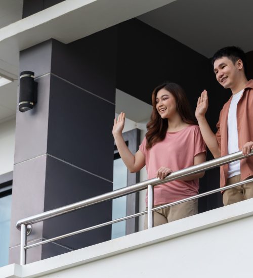 quarantine couple greeting neighbors from balcony of the home, coronavirus pandemic